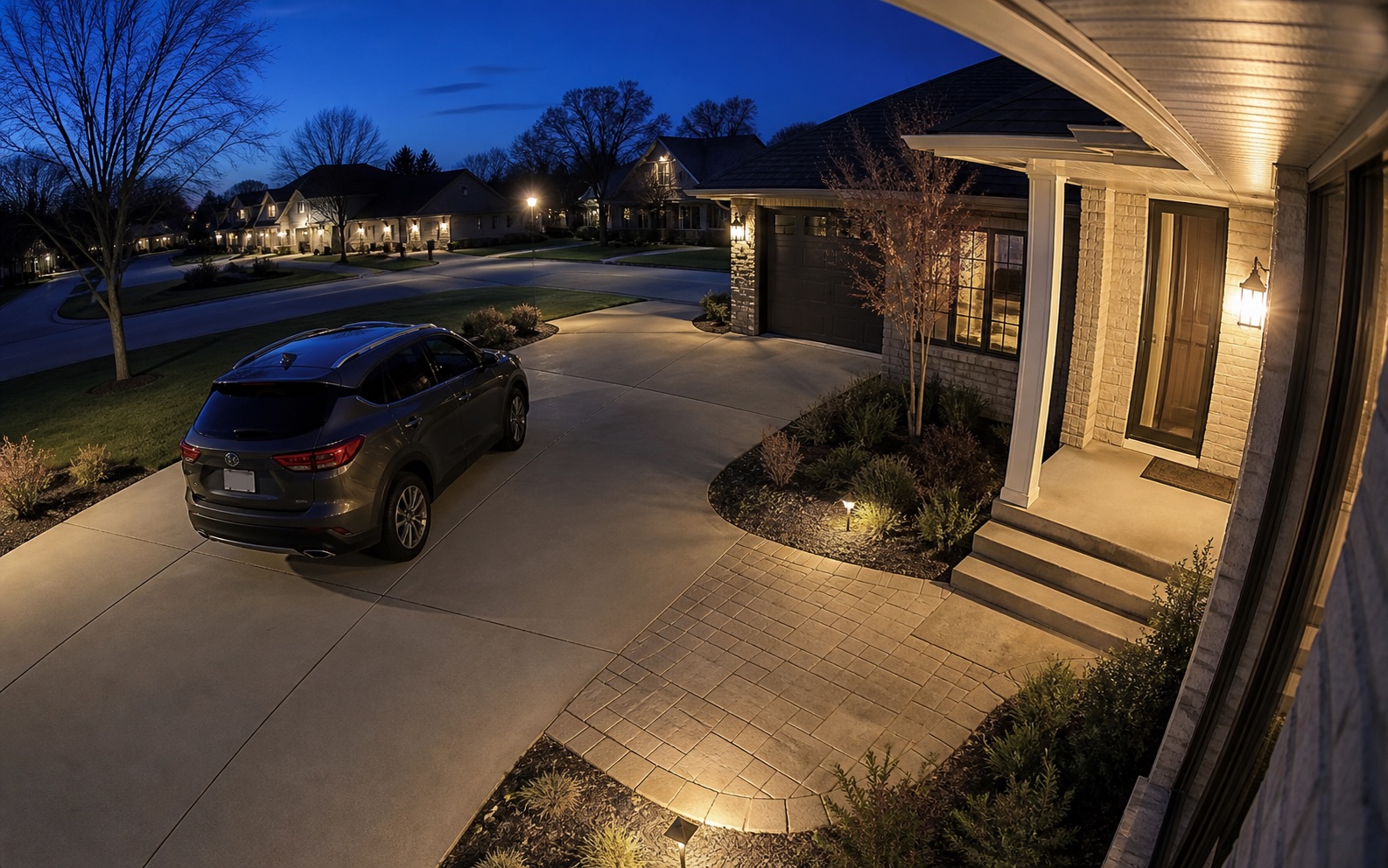 Illustrative dusk camera view covering a driveway and front entrance